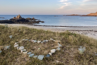 Perfectly placed stones in the shape of a heart looks out across Corbletts Bay