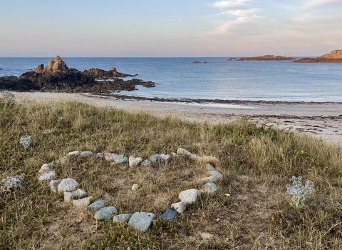 Perfectly placed stones in the shape of a heart looks out across Corbletts Bay